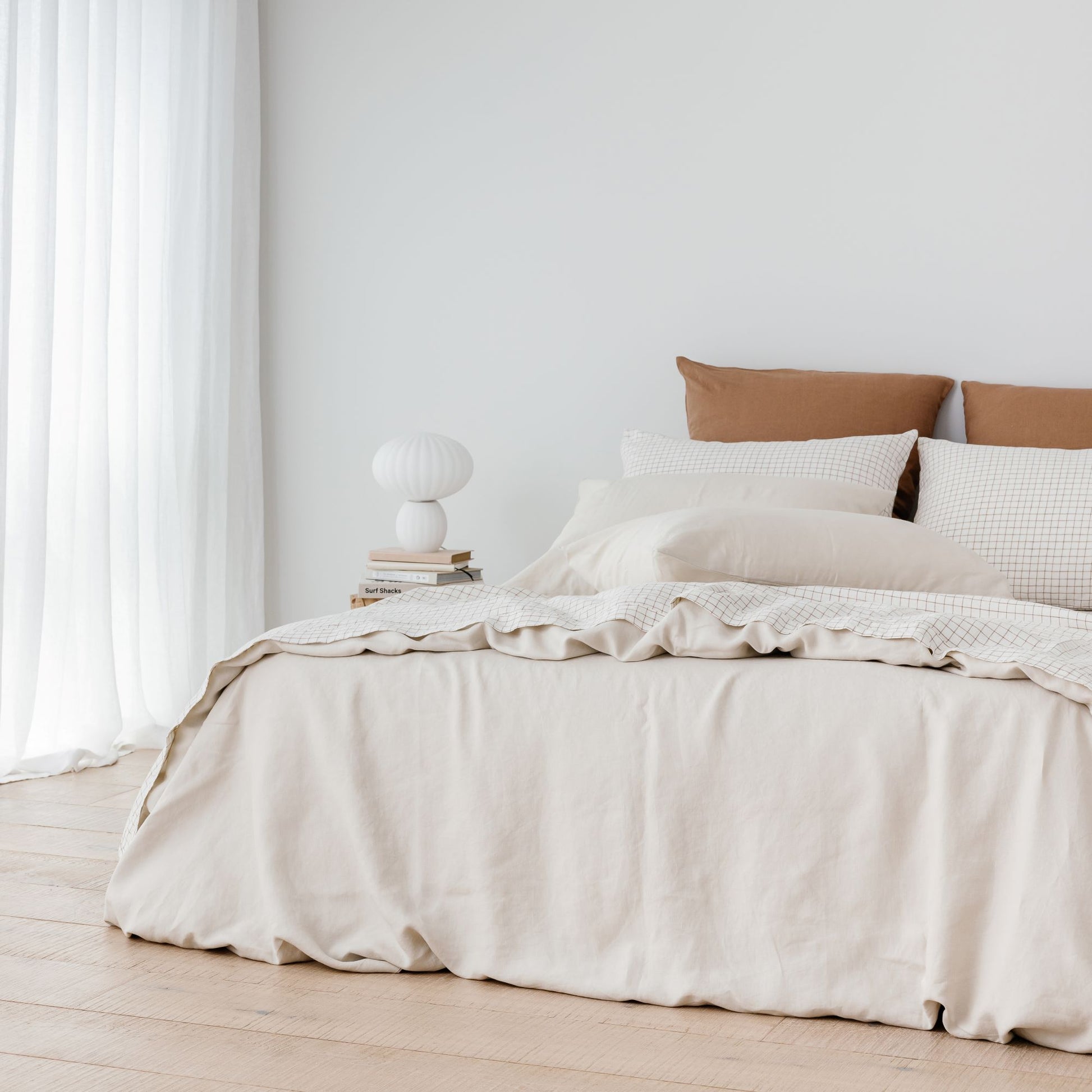 Foxtrot Home French Flax Linen styled with a Malt Brown Grid Sheets and an Oat Duvet