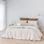 Foxtrot Home French Flax Linen styled with Malt Brown Grid Sheet Sets and an Oat Duvet