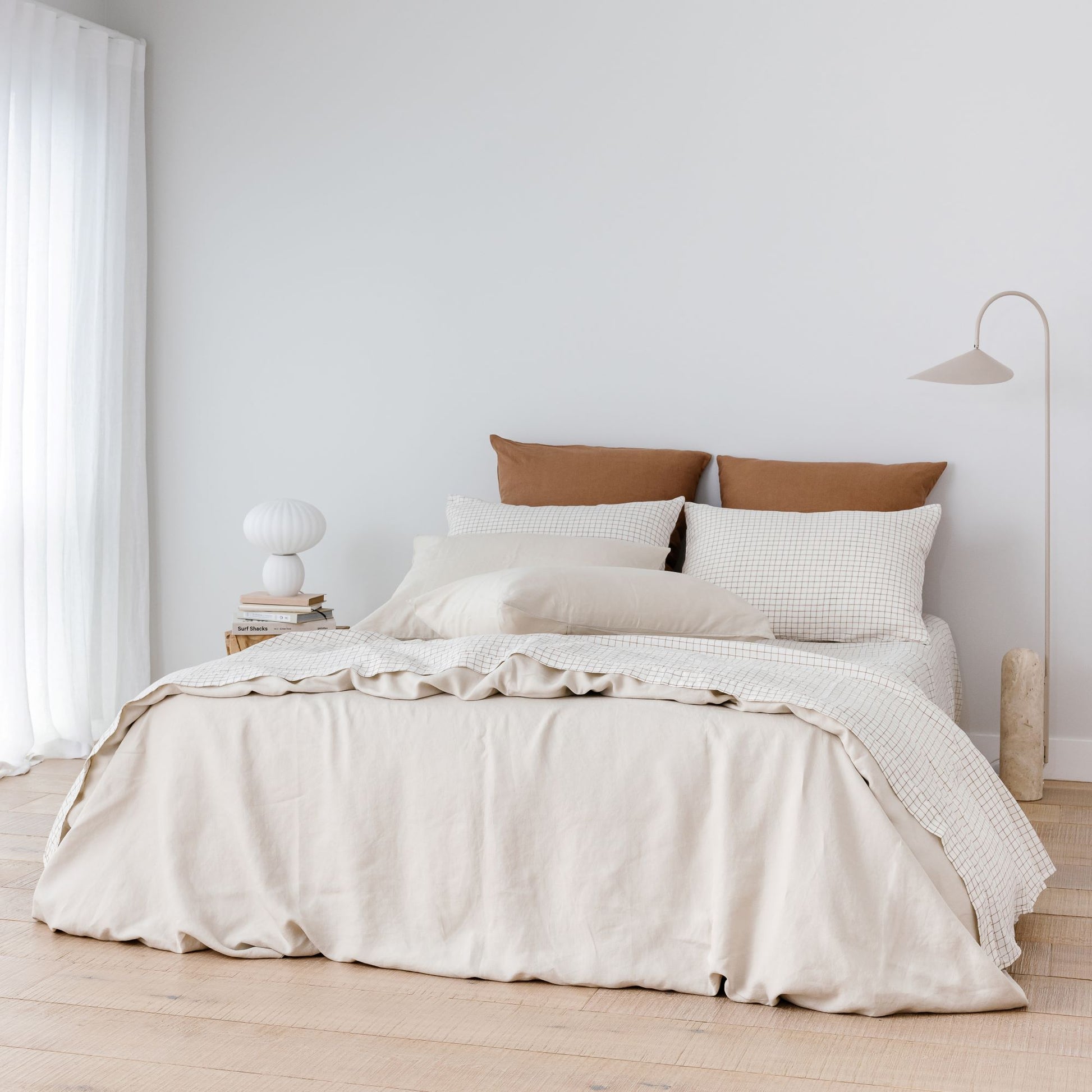 Foxtrot Home French Flax Linen styled with Malt Brown Grid Sheet Sets and an Oat Duvet
