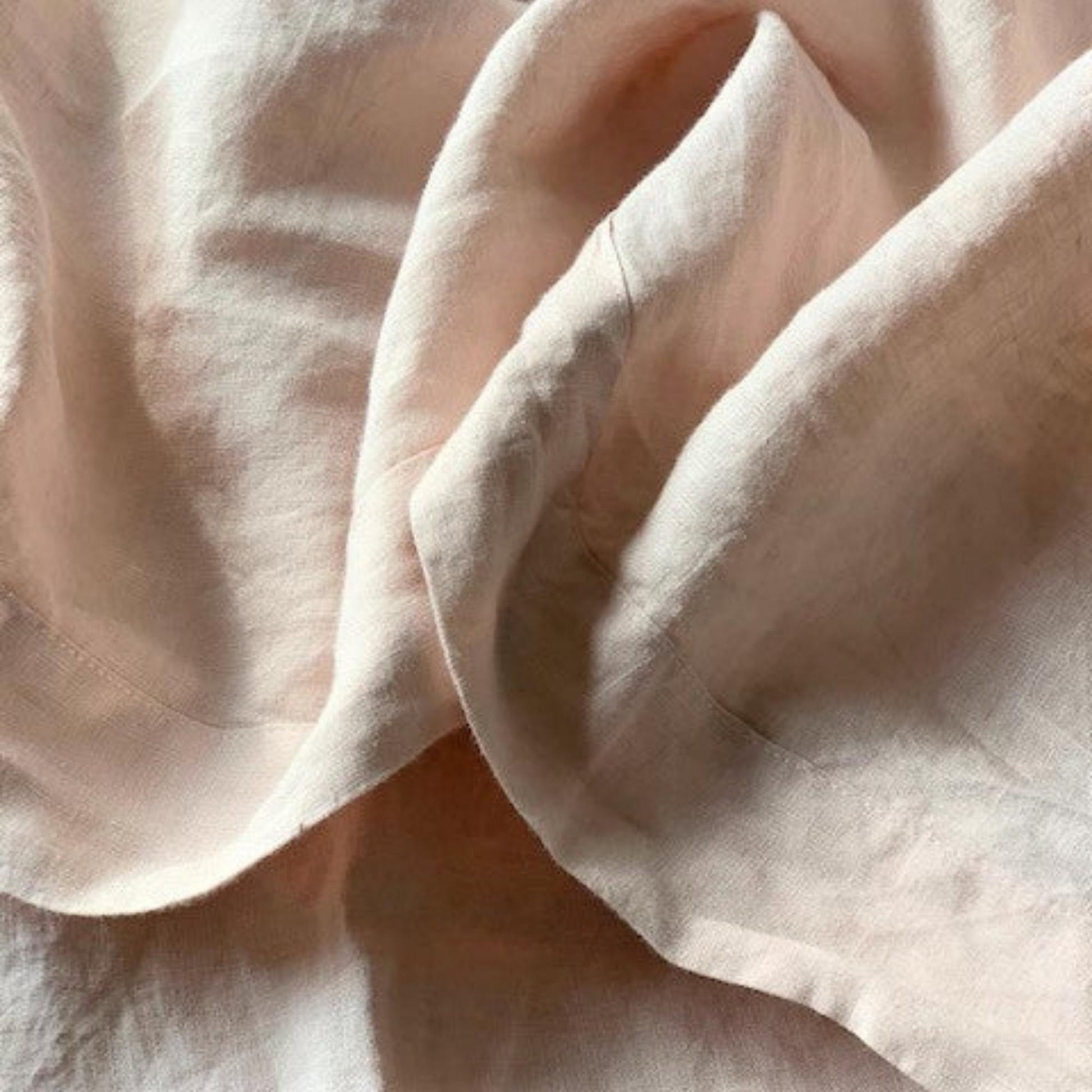 Foxtrot Home French Flax Linen styled in a baby's bedroom with Blush Pink Cot Sheet and Bassinet Sheets.