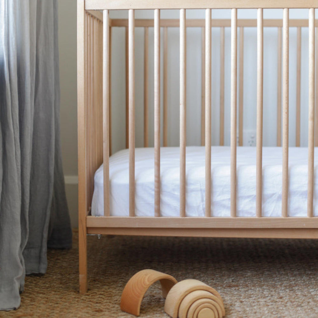 Foxtrot Home French Flax Linen styled in a baby's bedroom with Brilliant White Cot Sheet and Bassinet Sheets.