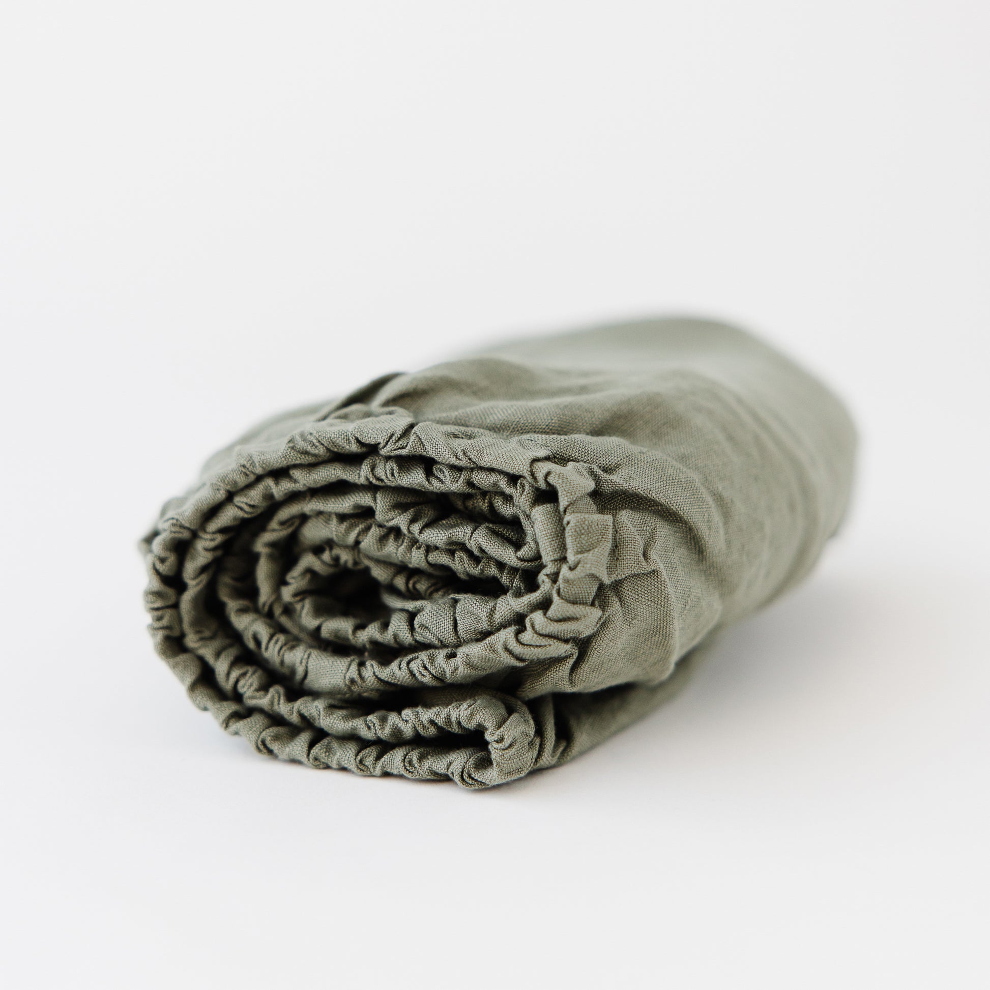 Foxtrot Home French Flax Linen styled in a baby's bedroom with Cactus Cot Sheet and Bassinet Sheets.