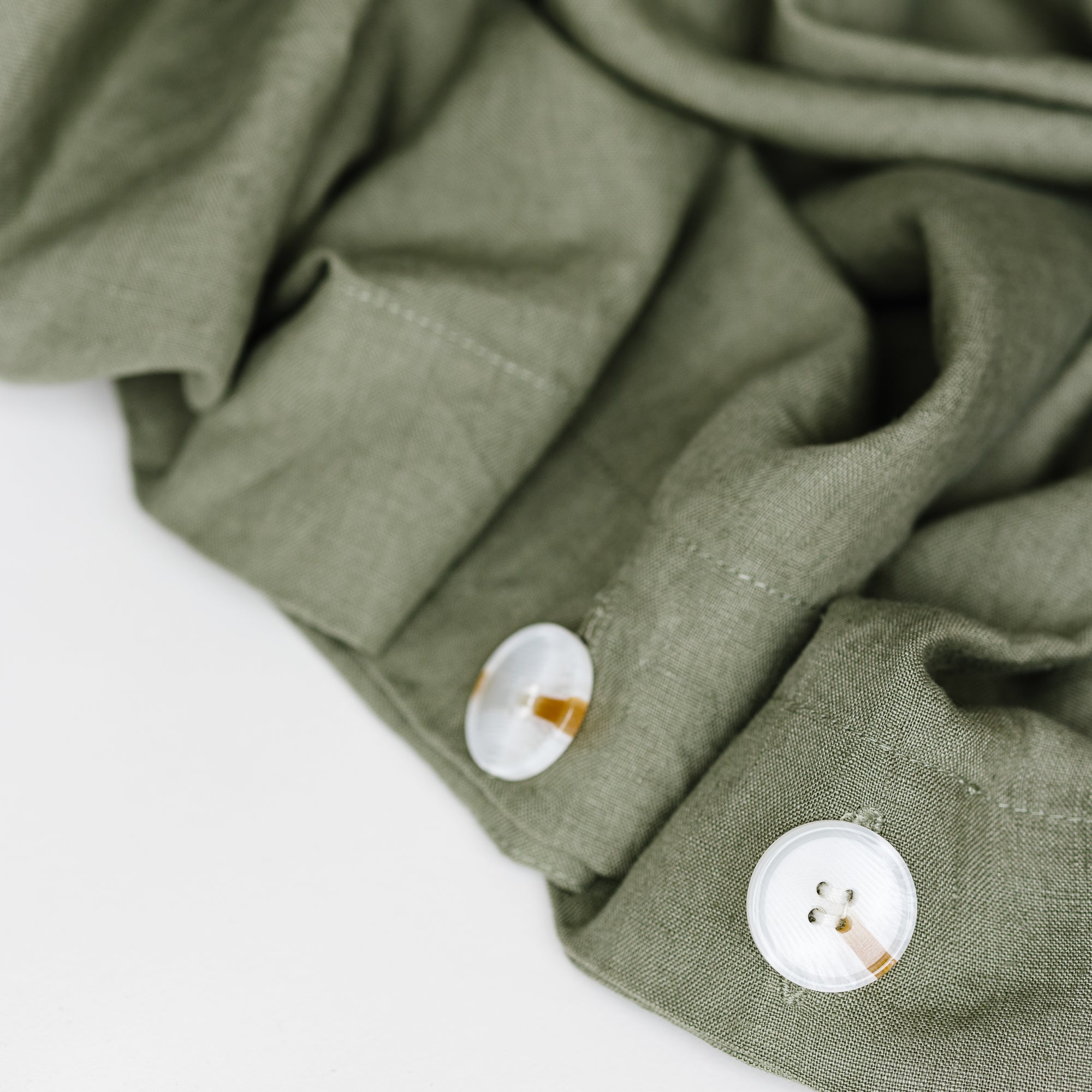 Foxtrot Home French Flax Linen styled in a bedroom with Cactus Green Duvet, Oat Sheets Set and Pillowcases.