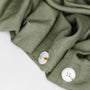 Foxtrot Home French Flax Linen styled in a bedroom with Cactus Green Duvet, Oat Sheets Set and Pillowcases.
