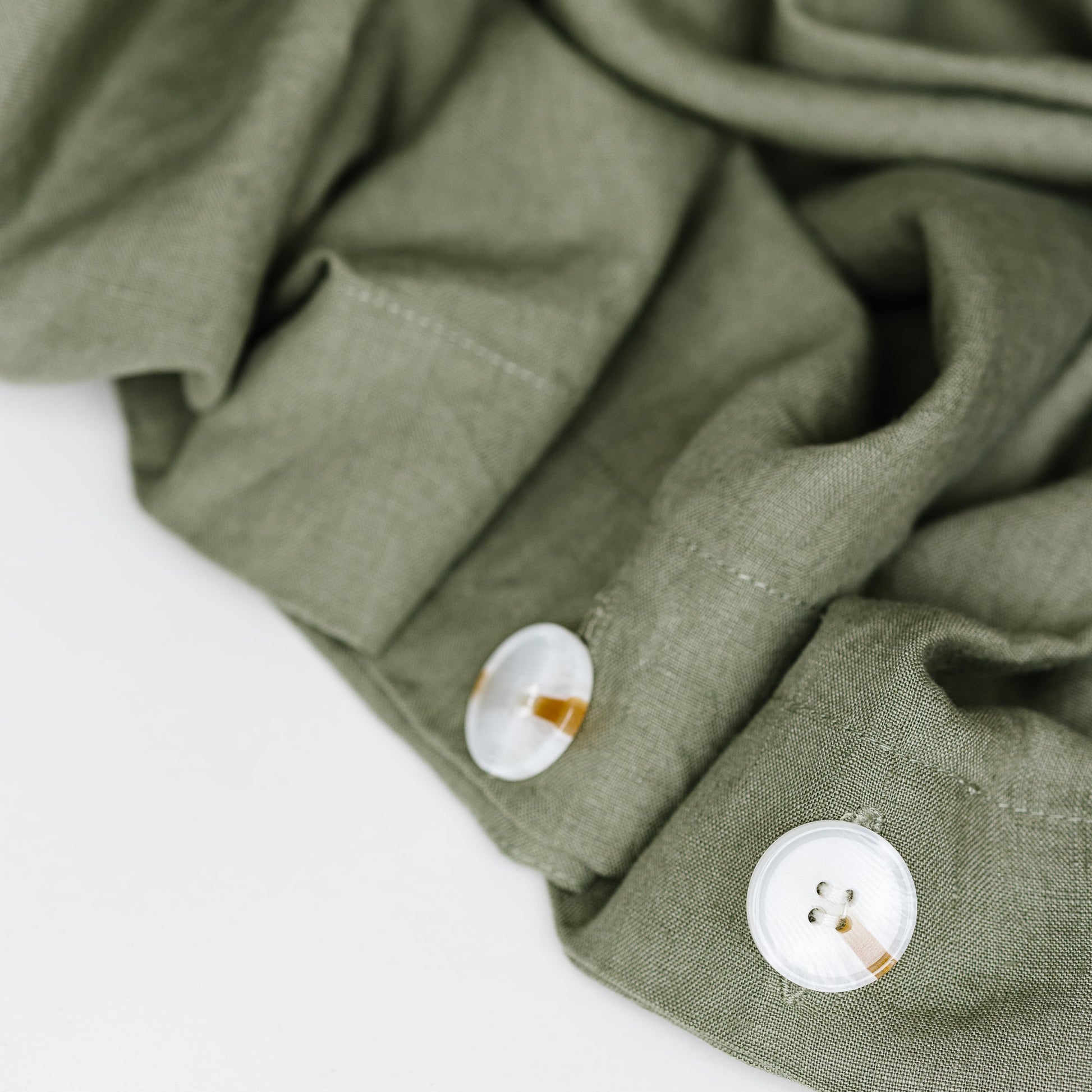 Foxtrot Home French Flax Linen styled in a bedroom with Cactus Green Duvet, Oat Sheets Set and Pillowcases.