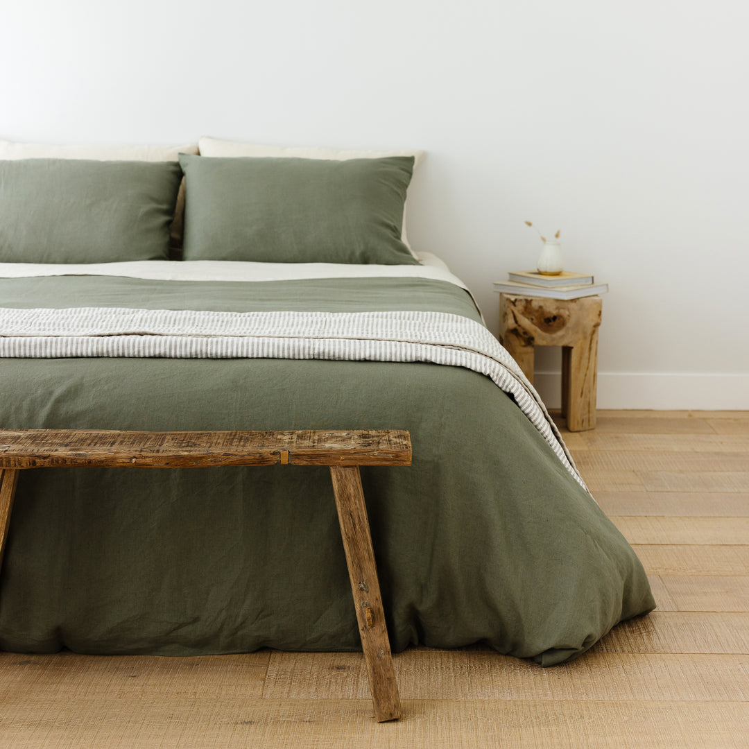 Foxtrot Home French Flax Linen styled in a bedroom with Cactus Green Duvet, Oat Sheets Set and Pillowcases.