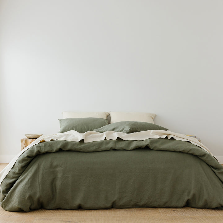 Foxtrot Home French Flax Linen styled in a bedroom with Cactus Green Duvet, Oat Sheets Set and Pillowcases.
