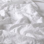 Foxtrot Home French Flax Linen styled in a baby's bedroom with a Brilliant White Cot Duvet.