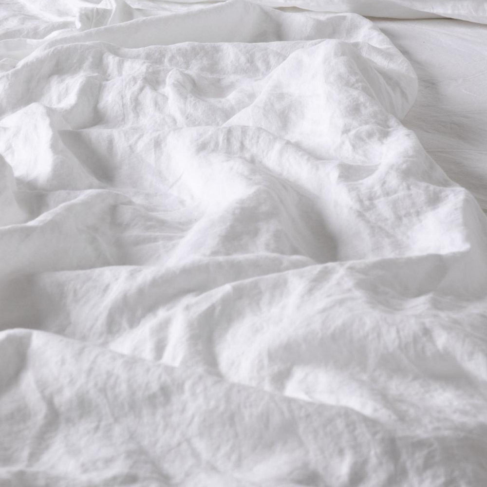 Foxtrot Home French Flax Linen styled in a baby's bedroom with a Brilliant White Cot Duvet.