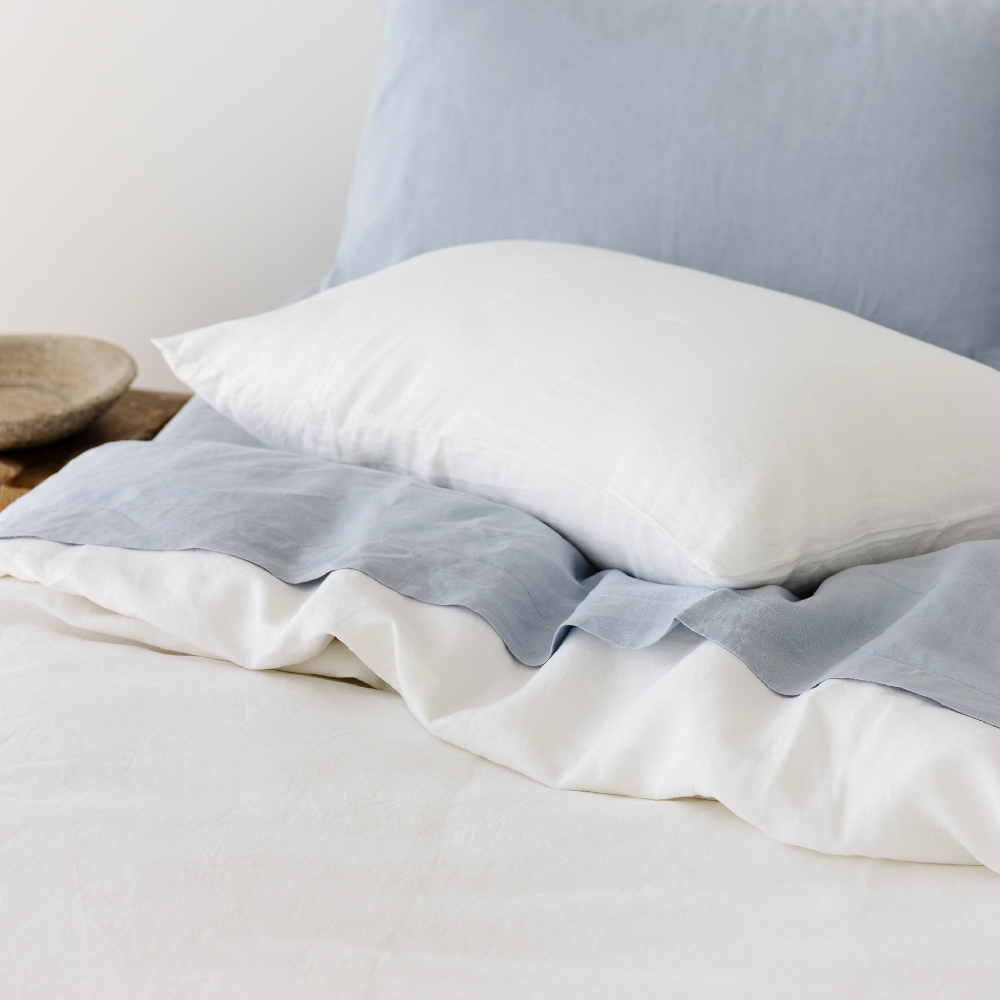 Foxtrot Home French Flax Linen styled in a bedroom with Brilliant White Duvet, Powder Blue Sheets Set and Pillowcases.