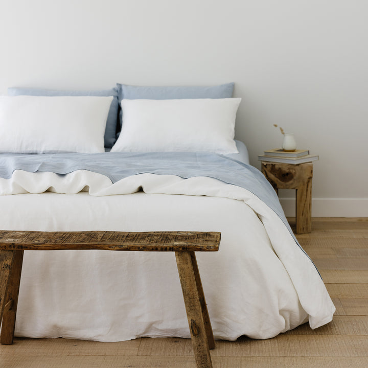 Foxtrot Home French Flax Linen styled in a bedroom with Brilliant White Duvet, Powder Blue Sheets Set and Pillowcases.