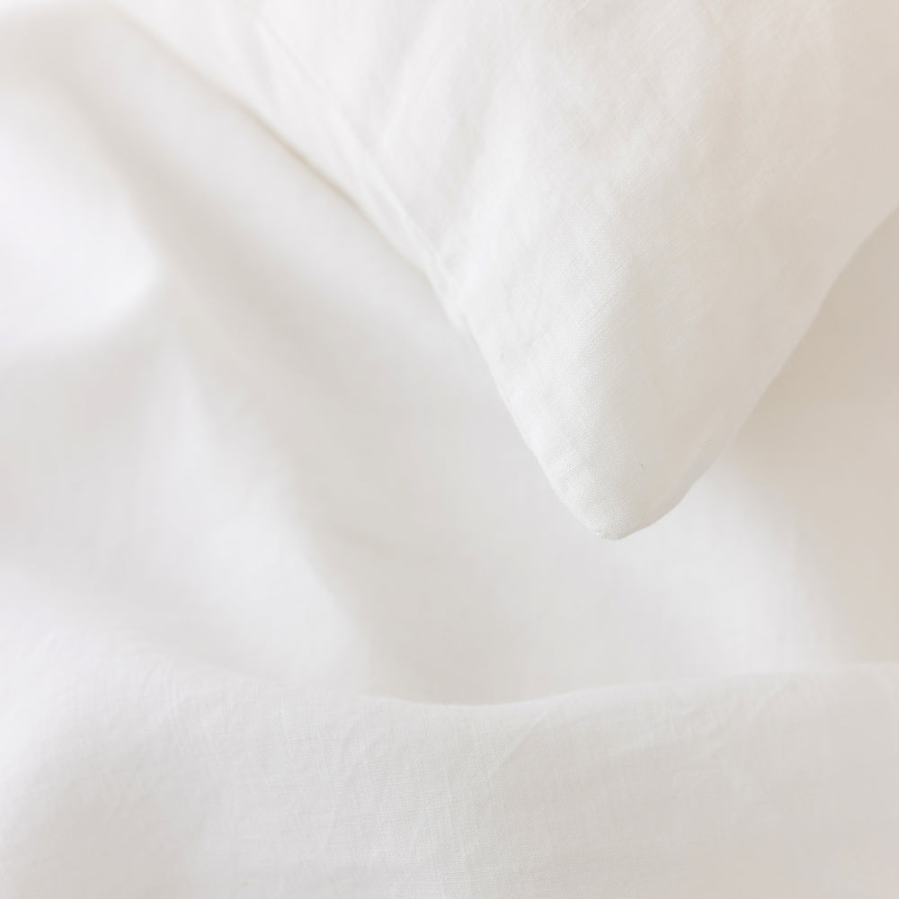 Foxtrot Home French Flax Linen styled in a bedroom with Brilliant White Pillowcases.