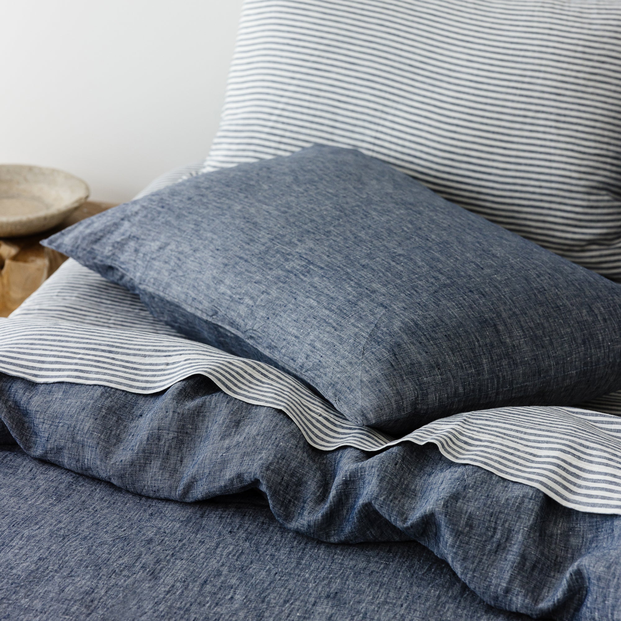 Foxtrot Home French Flax Linen styled in a bedroom with Denim Blue Duvet.