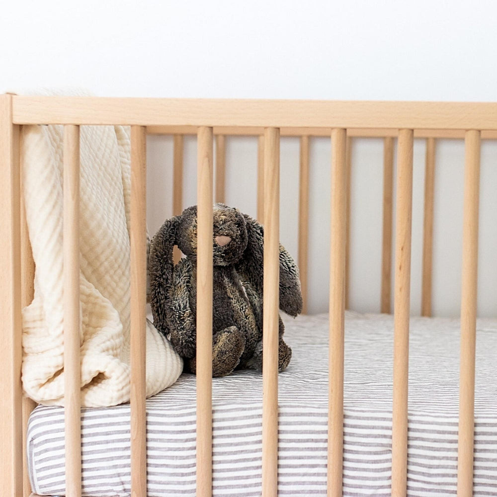 Foxtrot Home French Flax Linen styled in a baby's bedroom with Grey Stripes Cot Sheet and Bassinet Sheets.