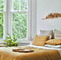Foxtrot Home French Flax Linen styled in a bedroom with Ginger Honey Duvet.