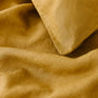 Foxtrot Home French Flax Linen styled in a bedroom with Ginger Honey Duvet.