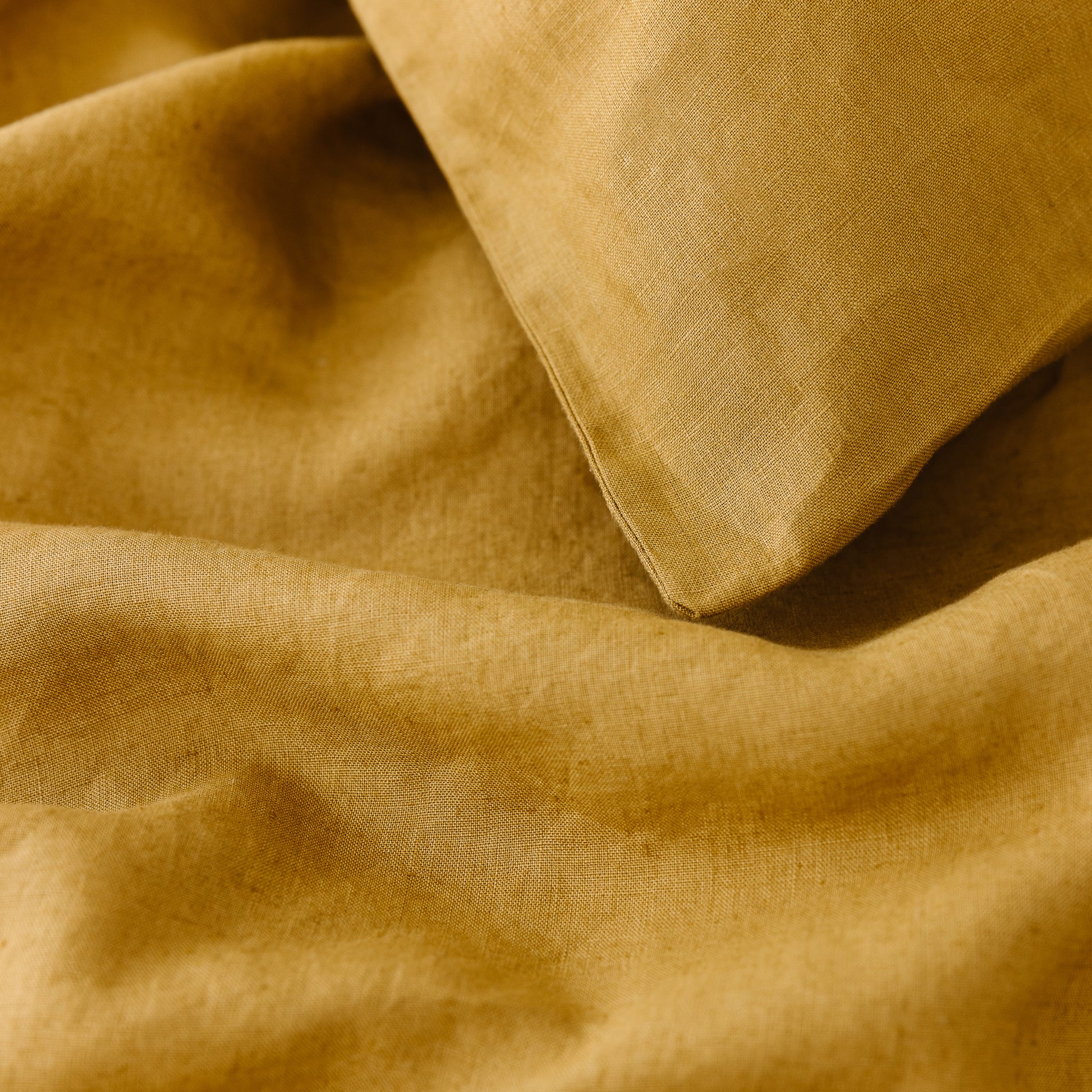Foxtrot Home French Flax Linen styled in a bedroom with Ginger Honey Duvet.