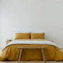 Foxtrot Home French Flax Linen styled in a bedroom with Ginger Honey Duvet.