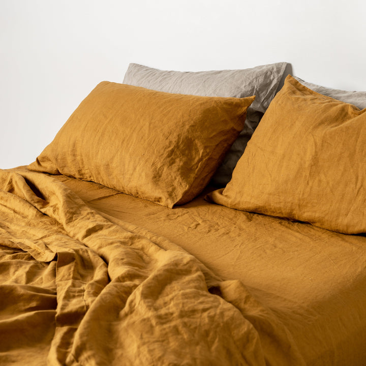 Foxtrot Home French Flax Linen styled in a bedroom with Ginger Honey Fitted Sheet.