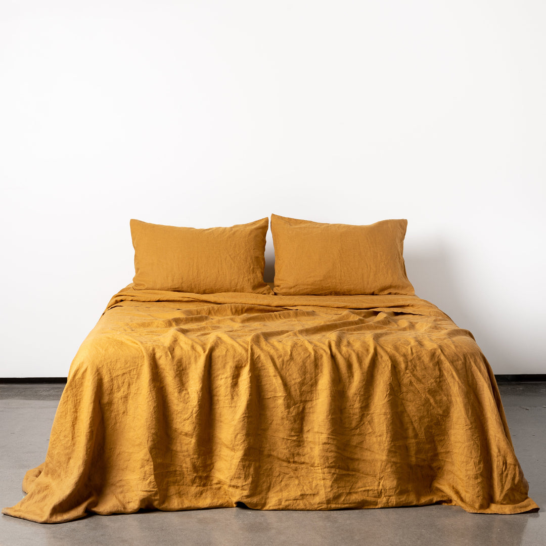 Foxtrot Home French Flax Linen styled in a bedroom with Ginger Honey Fitted Sheet.