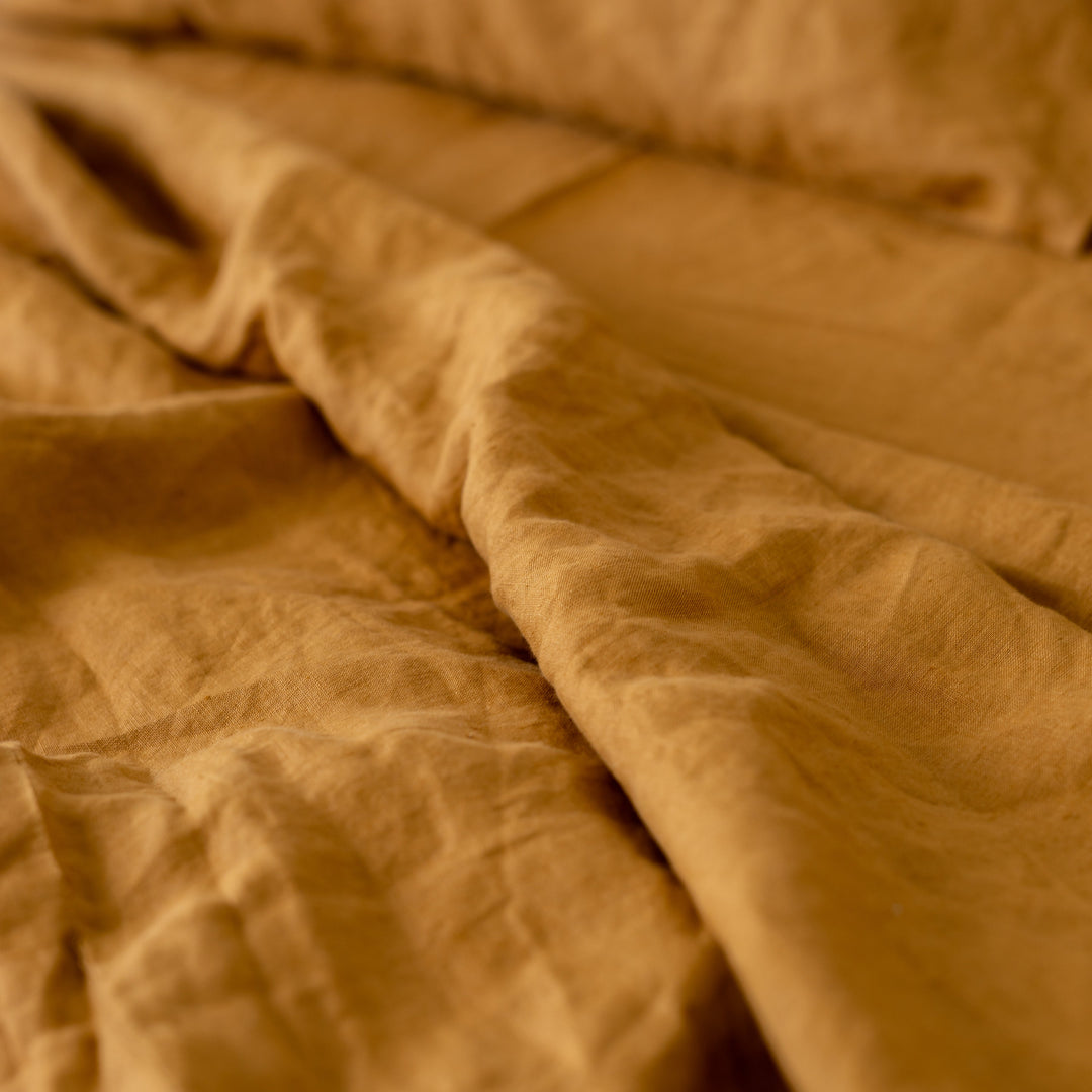 Foxtrot Home French Flax Linen styled in a bedroom with Ginger Honey Flat Sheet.