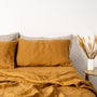 Foxtrot Home French Flax Linen styled in a bedroom with Honey Ginger Pillowcases.