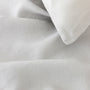 Foxtrot Home French Flax Linen styled in a bedroom with Light Grey Duvet.