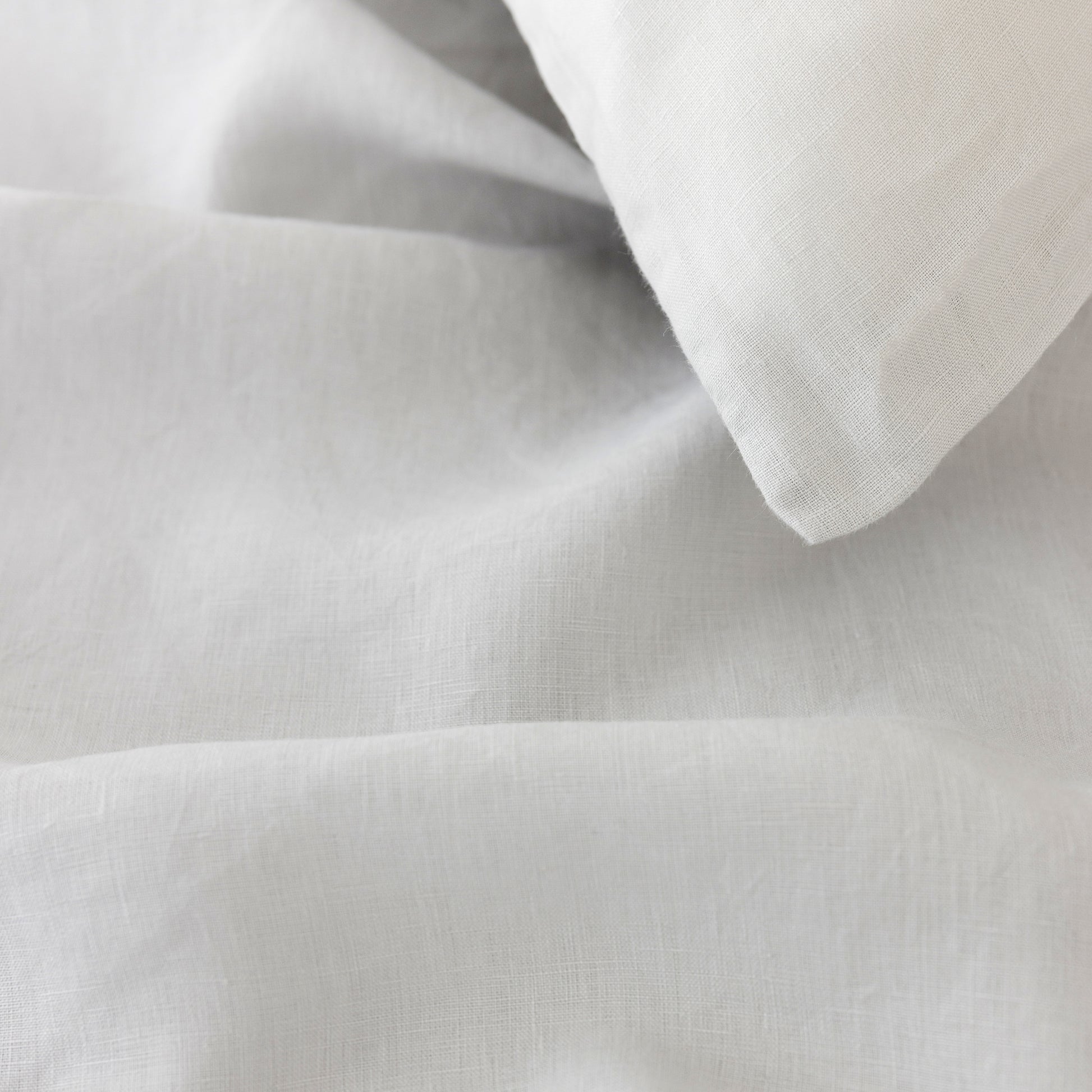 Foxtrot Home French Flax Linen styled in a bedroom with Light Grey Duvet.