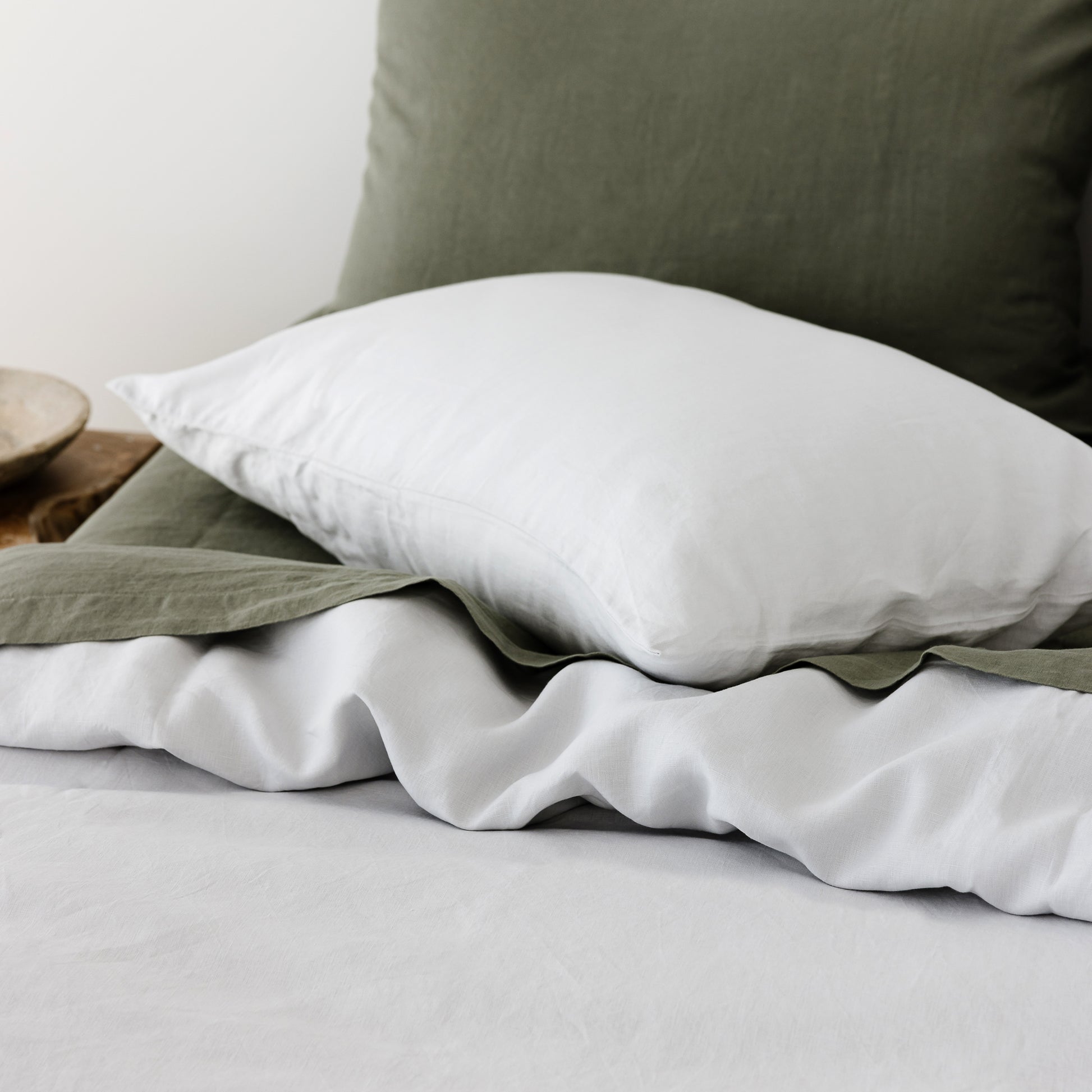 Foxtrot Home French Flax Linen styled in a bedroom with Light Grey Duvet.