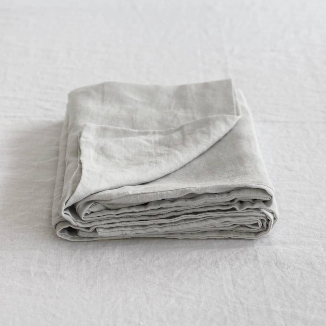 Foxtrot Home French Flax Linen styled in a bedroom with Light Grey Pillowcases.