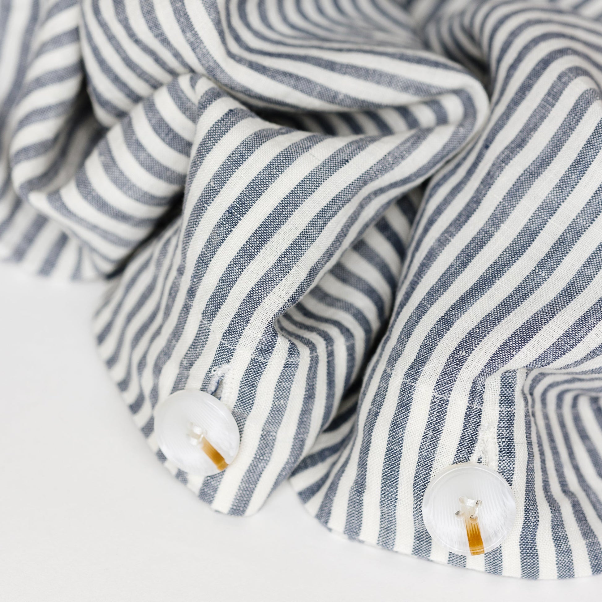 Foxtrot Home French Flax Linen styled in a bedroom with Navy Stripes Duvet.