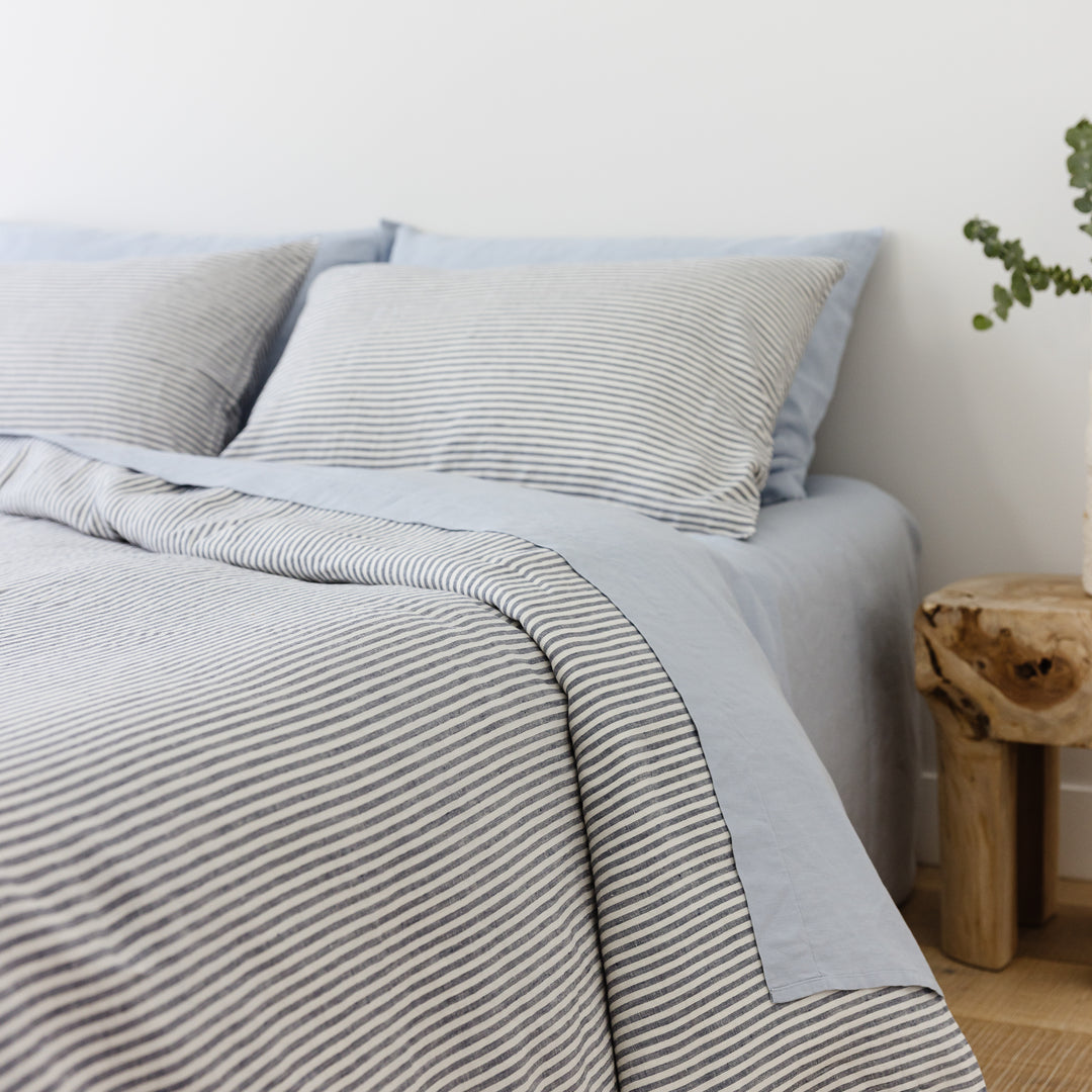 Foxtrot Home French Flax Linen styled in a bedroom with Navy Stripes Duvet.