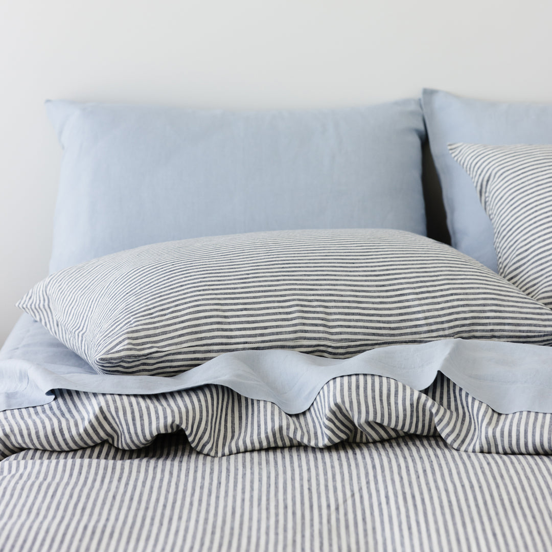 Foxtrot Home French Flax Linen styled in a bedroom with Navy Stripes Duvet.