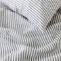 Foxtrot Home French Flax Linen styled in a bedroom with Navy Stripes Duvet.