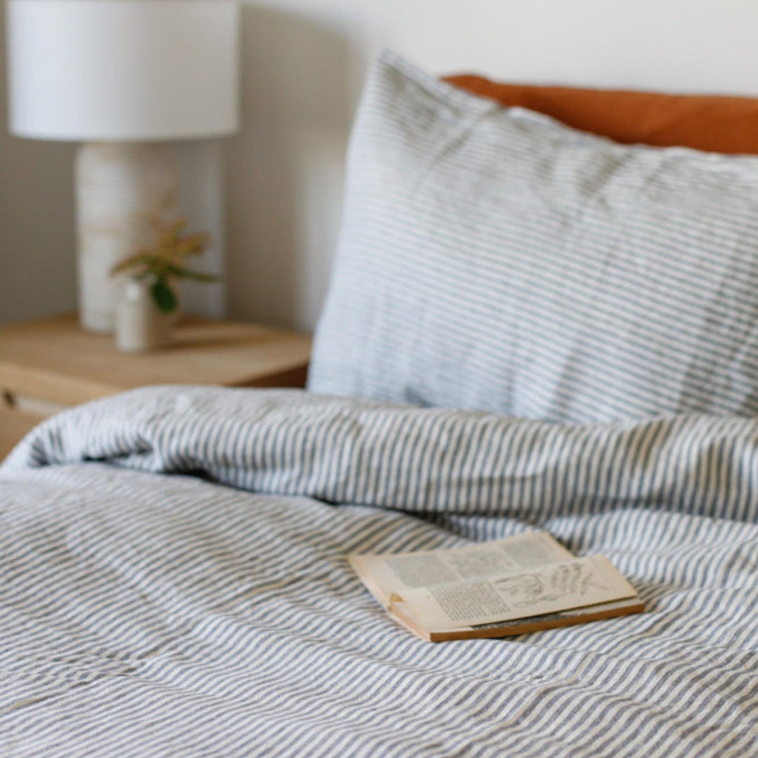Foxtrot Home French Flax Linen styled in a bedroom with Navy Stripes Sheets Set.