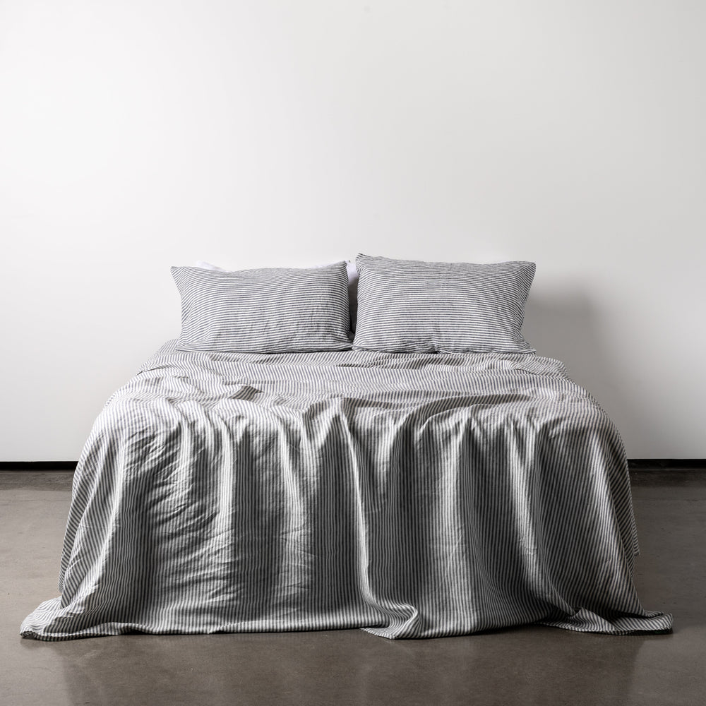 Foxtrot Home French Flax Linen styled in a bedroom with Navy Stripes Sheets Set.