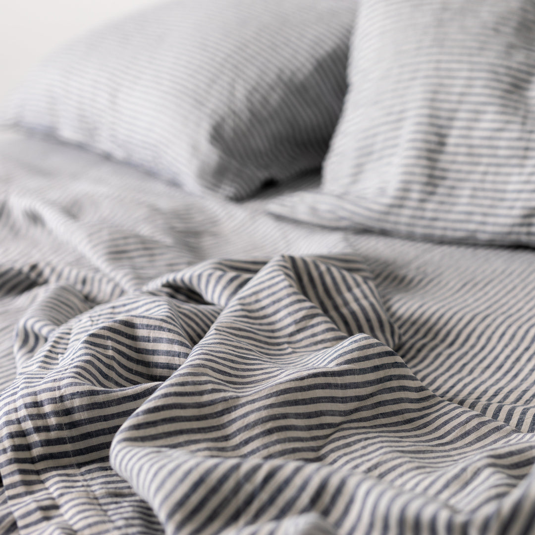 Foxtrot Home French Flax Linen styled in a bedroom with Navy Stripes Sheets Set.