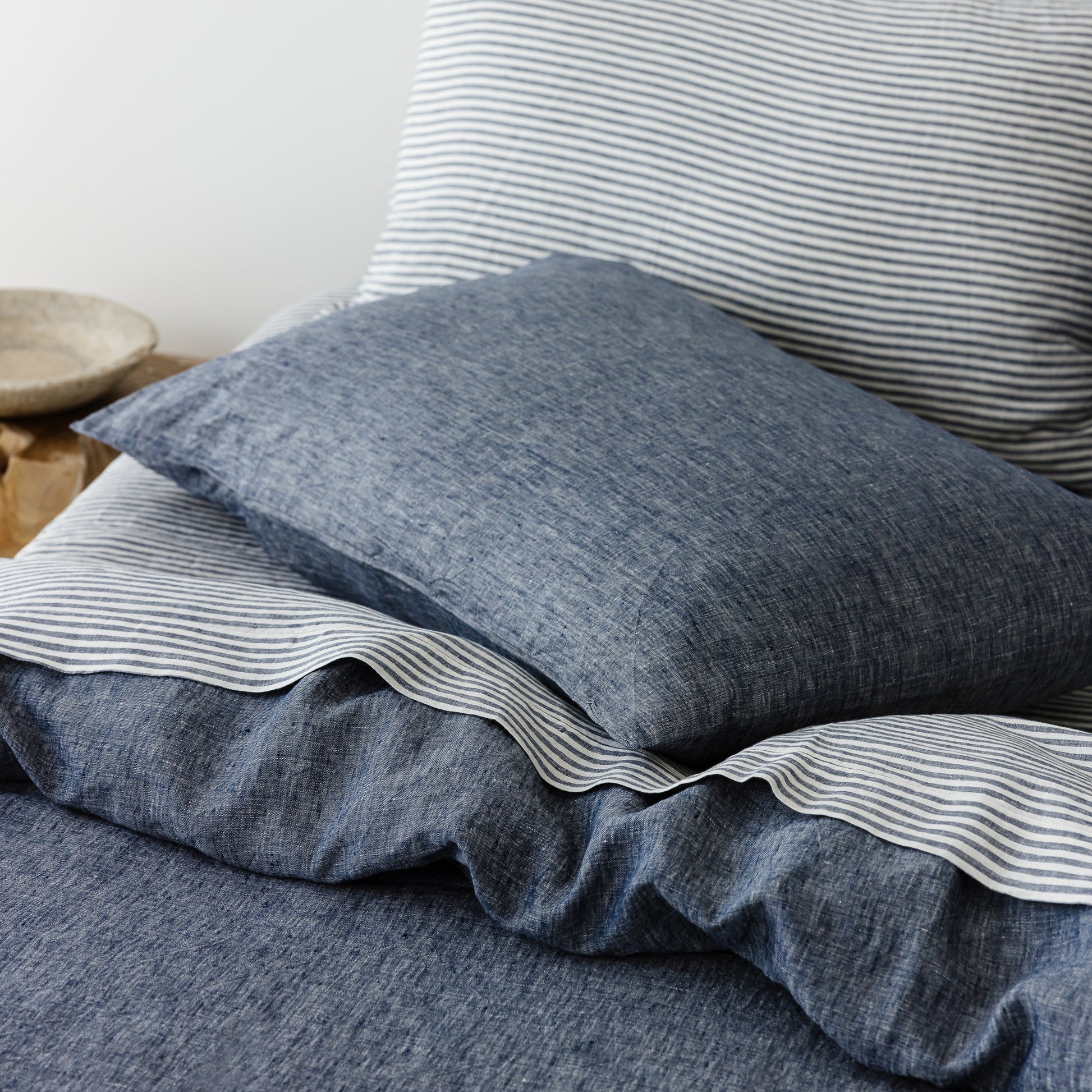 Foxtrot Home French Flax Linen styled in a bedroom with Navy Stripes Sheets Set.