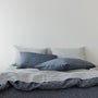 Foxtrot Home French Flax Linen styled in a bedroom with Navy Stripes Pillowcases.