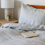 Foxtrot Home French Flax Linen styled in a bedroom with Navy Stripes Pillowcases.