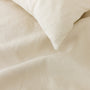 Foxtrot Home French Flax Linen styled in a bedroom with Oat Duvet.