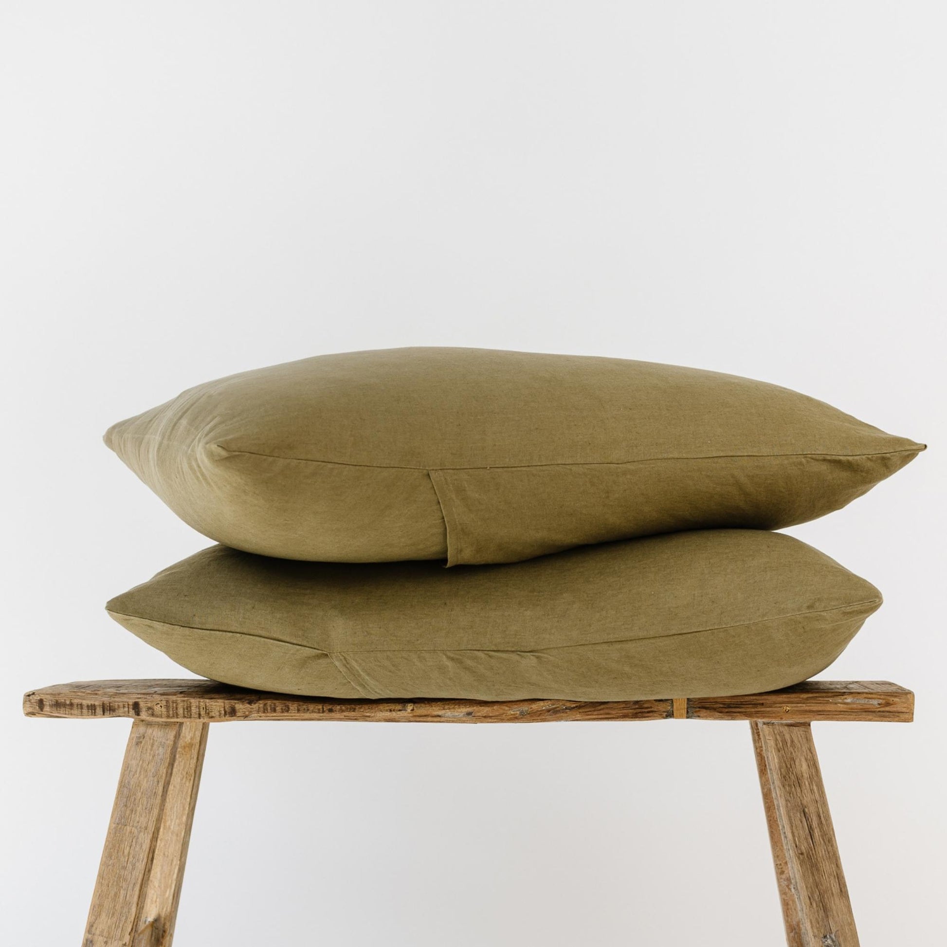 Foxtrot Home French Flax Linen styled in a bedroom with Olive Green Pillowcases.