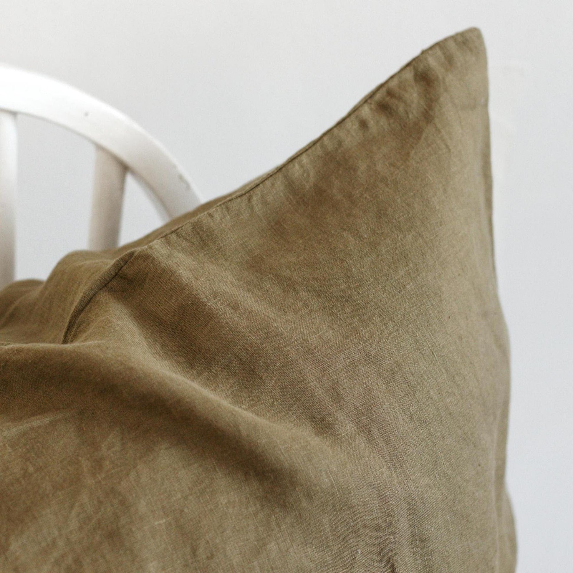Foxtrot Home French Flax Linen styled in a bedroom with Olive Green Pillowcases.