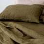 Foxtrot Home French Flax Linen styled in a bedroom with Olive Green Pillowcases.