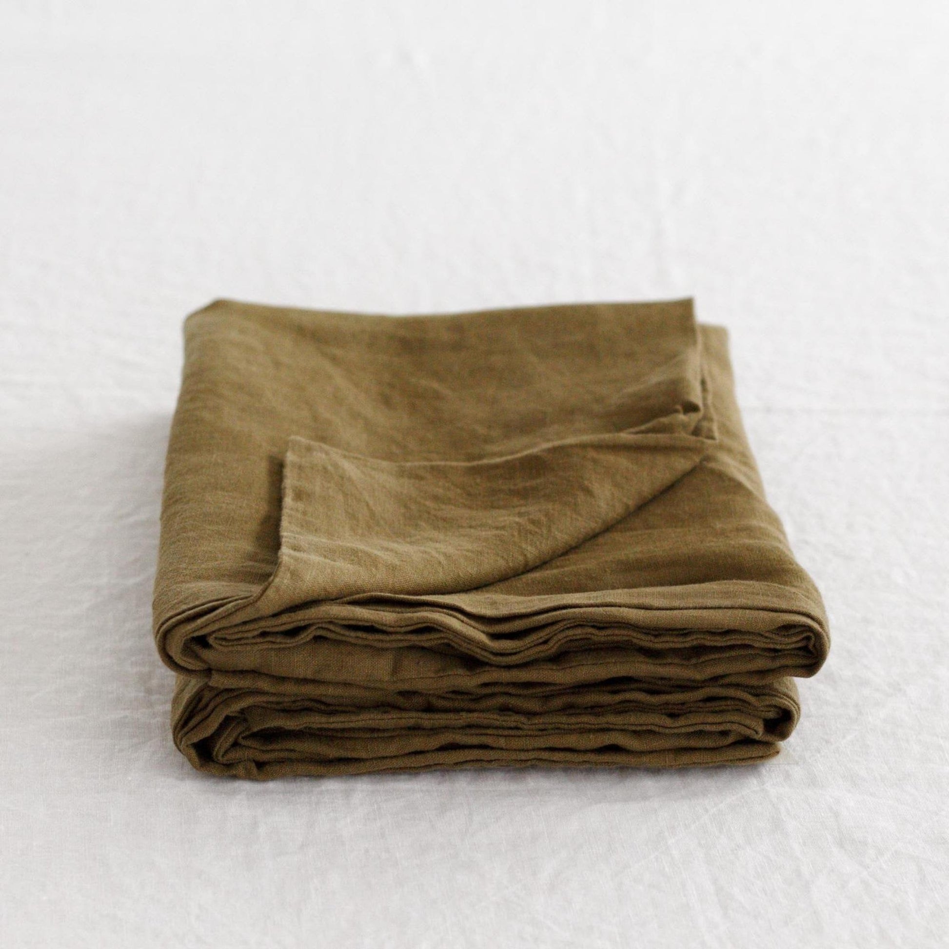 Foxtrot Home French Flax Linen styled in a bedroom with Olive Green Pillowcases.