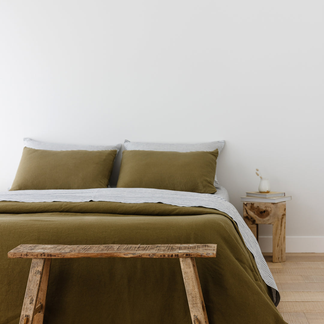Foxtrot Home French Flax Linen styled in a bedroom with Olive Green Pillowcases.