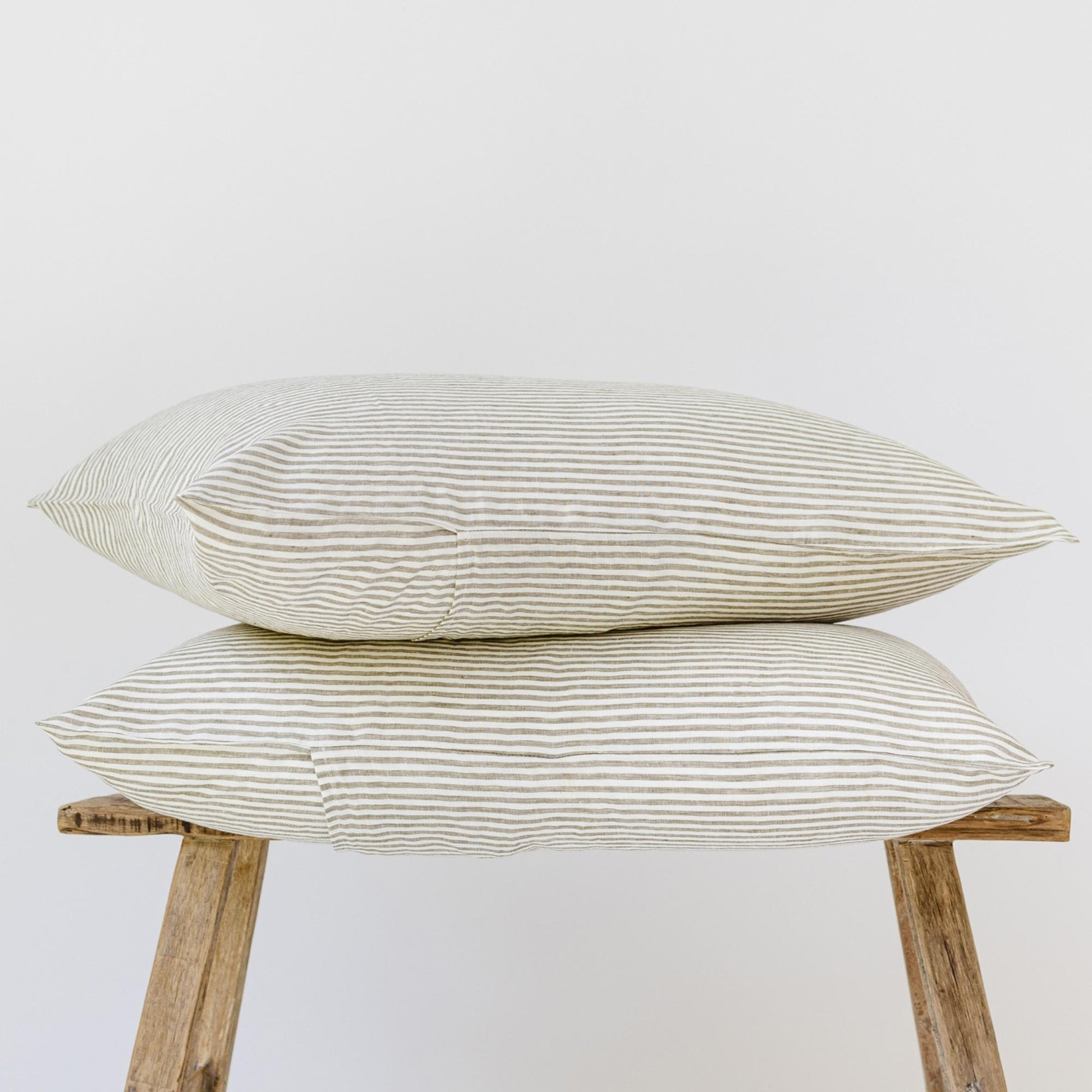 Foxtrot Home French Flax Linen styled in a bedroom with Olive Green Stripes Pillowcases.