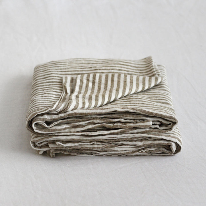 Foxtrot Home French Flax Linen styled in a bedroom with Olive Green Stripes Pillowcases.