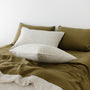 Foxtrot Home French Flax Linen styled in a bedroom with Olive Green Stripes Pillowcases.