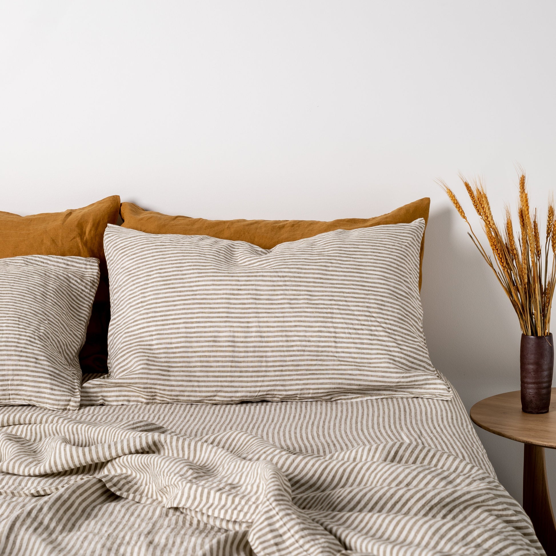 Foxtrot Home French Flax Linen styled in a bedroom with Olive Green Stripes Pillowcases.